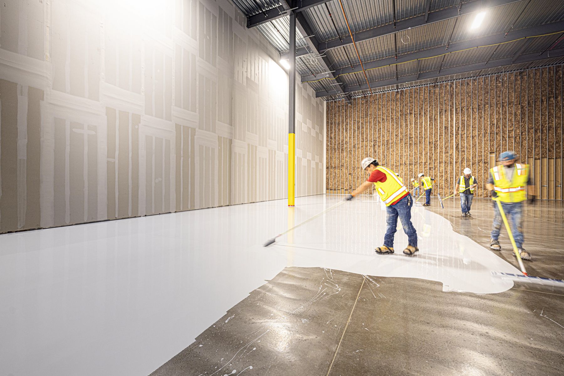 Coating being applied to a prepared slab
